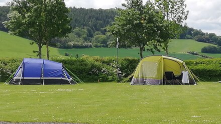bue & green tent & hills