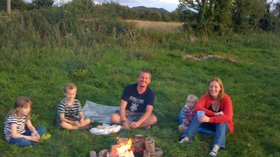Family round fire - One of the many young families enjoying the outdoor life