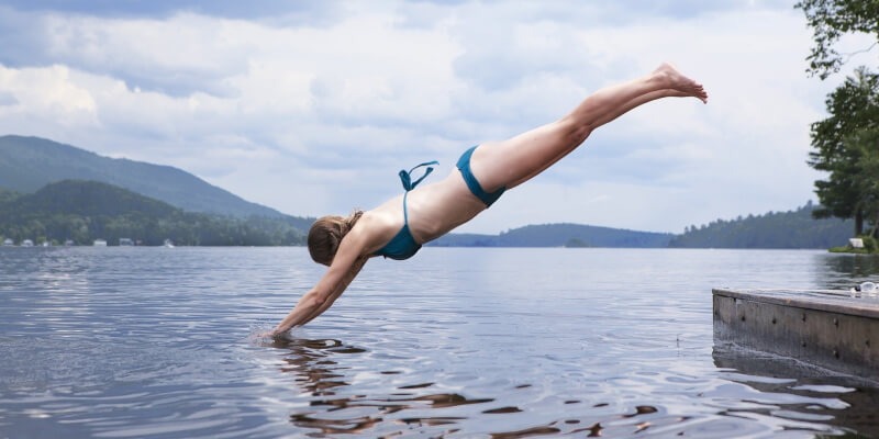 A woman diving into a lake - <i>Wild swimming</i>