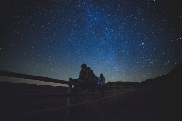 People looking at the stars at night