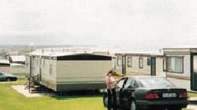 Holiday homes with a car on the parking on the park